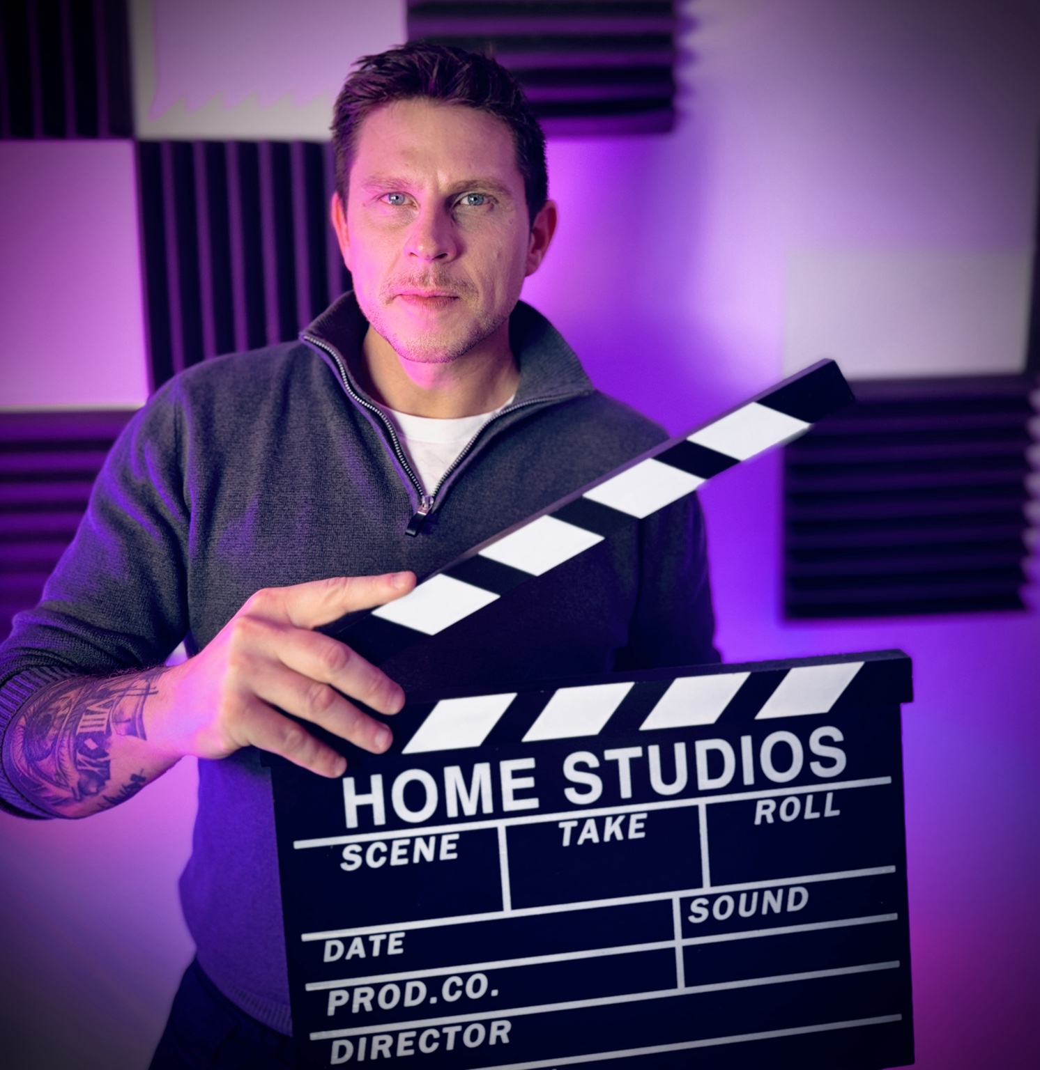 Adam James holding a clapperboard