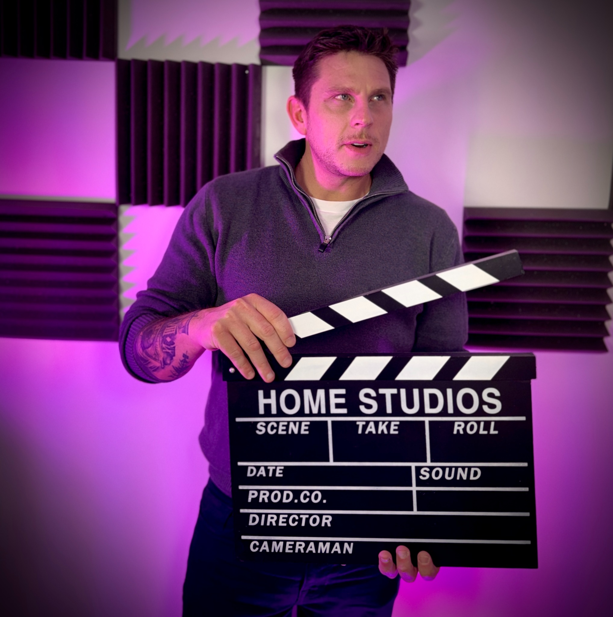 Adam James holding a clapperboard
